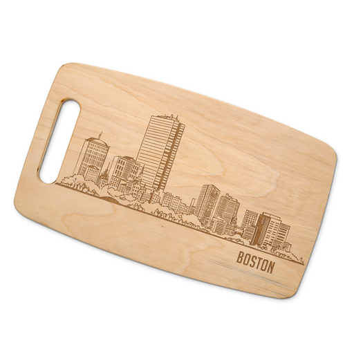 Boston skyline maple cutting board displayed on a rustic wood table with red and white gingham fabric.
