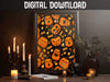 DIGITAL DOWNLOAD: halloween pumpkin pattern art print within elegant black frame in front of black wall sitting ontop of brown counter surrounded by halloween decor such as candles, papers, potted plant, and a black skull