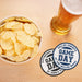 Blue and green Game Day coasters displayed beside a bowl of chips and a glass of beer for a football watch party.