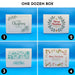 One dozen Christmas golf ball gift boxes shown in four printed designs, including botanical, wreath, blue sweater-style, and festive holiday illustration designs.
