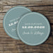 Stack of custom Save the Date coasters displayed on a rustic wood background. Personalized wedding favors for guests.
