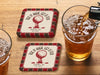 Custom square pulpboard coasters are shown laid out on a wooden surface. Two beer mugs are shown next to the coasters. The coasters feature design with an illustration of a golf ball on a tee, checkerboard border, and custom text.