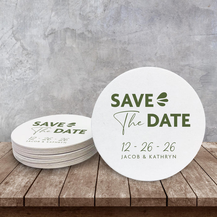 Custom Save the Date coaster displayed on a rustic wood surface. Features a clean modern layout with personalized wedding details.