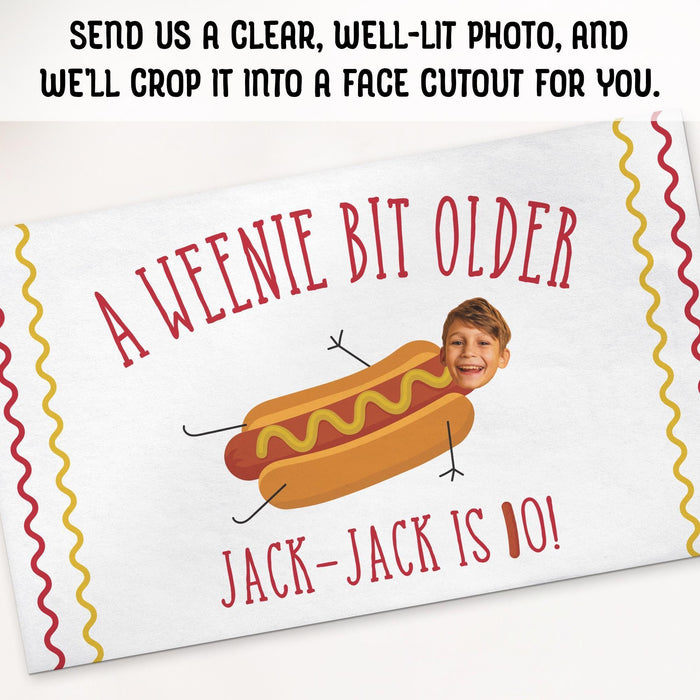 Face cutout feature showing how a customer's photo can be incorporated into the hot dog-themed birthday design.
