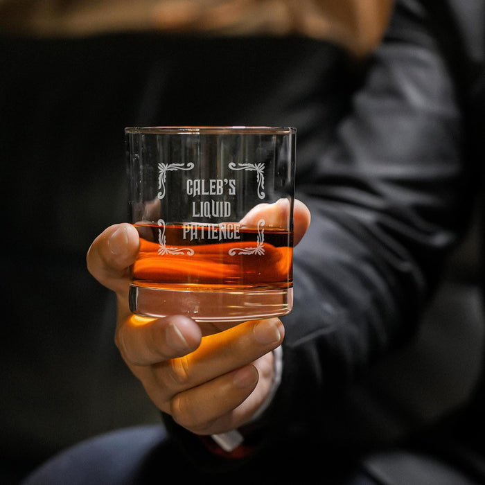 Close-up lifestyle photo of a personalized whiskey glass held in hand, featuring the “Caleb’s Liquid Patience” engraved design. The glass is filled with whiskey and ice, creating a premium gift presentation perfect for whiskey lovers.