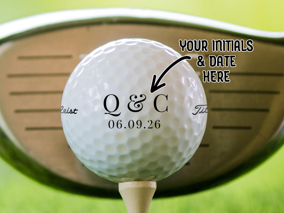 Titleist golf ball is shown sitting on a golf tee with a golf club behind it. Ball features custom printed Elegant Initials & Date Design. Text says: Your Initials & Date Here