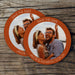 Stack of custom photo Save the Date coasters displayed on a rustic wood background. Personalized with a photo, names, and wedding date.