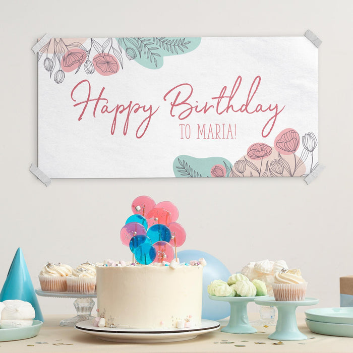 Personalized floral banner displayed with cake and party decorations.