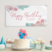 Personalized floral banner displayed with cake and party decorations.