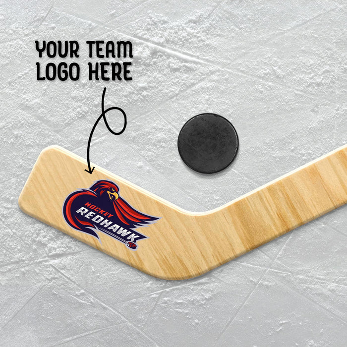 Close-up of a personalized goalie stick blade featuring a full-color team logo printed on natural birch wood with space for custom season or team text.