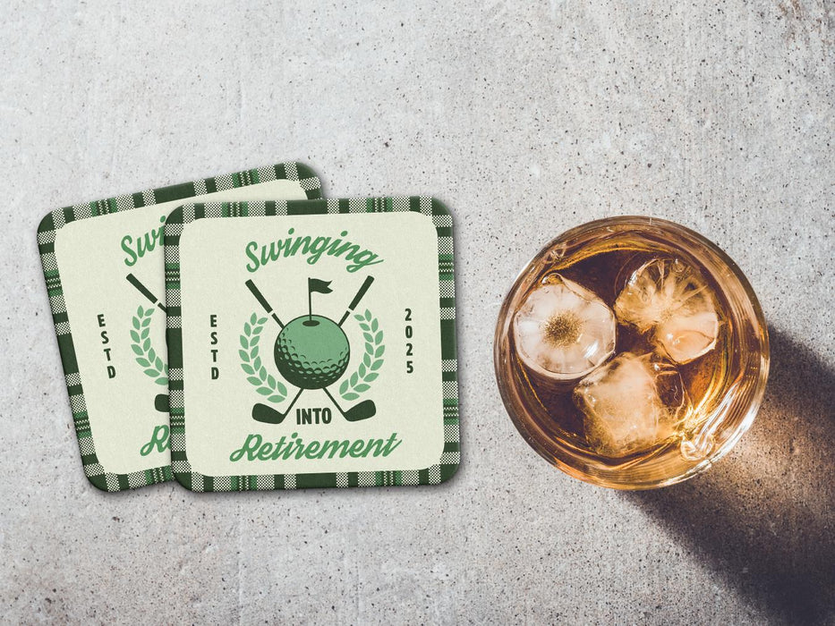 Two coasters sit on stone table with whiskey glass next to them. The coaster features design with illustrated golf ball, club, and flag on top with wreath surrounding it, argyle background pattern, and custom text.