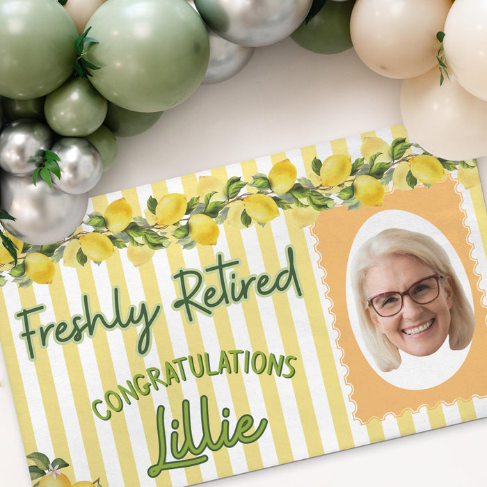Close-up angled view of the Freshly Retired banner showcasing the lemon border, striped background, personalized name, and custom photo area.