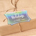 Slim rectangle personalized Christmas hang tag tied to a kraft paper wrapped gift with natural twine on a warm neutral background.