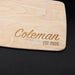 Angled close-up of the engraved Coleman cutting board showing the maple wood grain and personalized design.