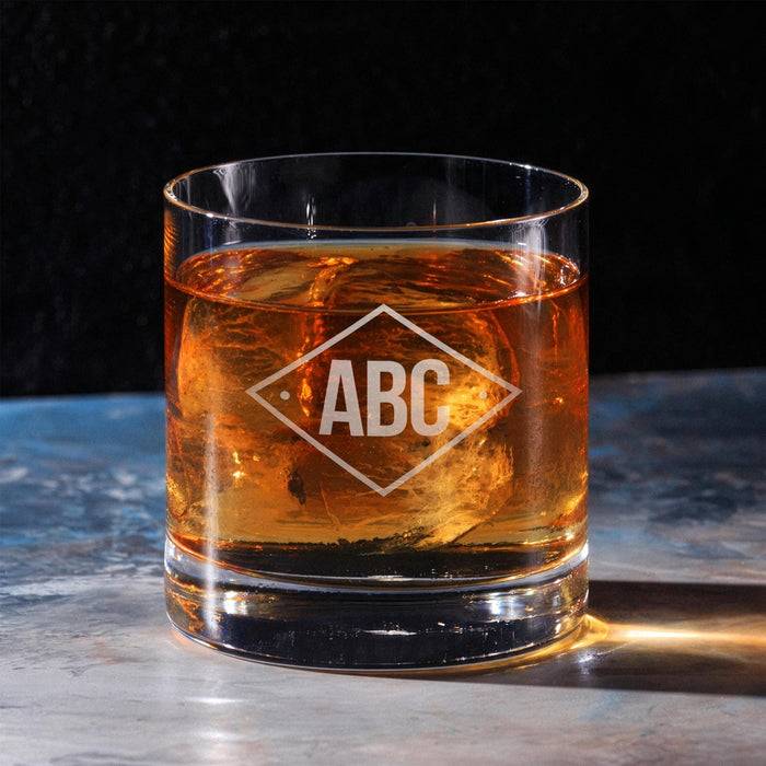 Clean hero-style image of the personalized whiskey glass on a marble surface, featuring the diamond initials engraving. The design appears crisp and professionally finished.
