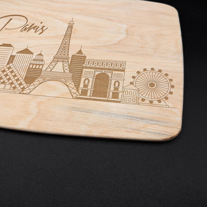 Close-up of the engraved Paris cityscape showing the Eiffel Tower, Arc de Triomphe, and other skyline details.