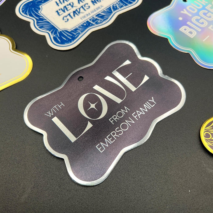Close-up display of the personalized “With Love” wedding gift tag in metallic silver foil on black cardstock. The elegant foil finish and custom names create a modern keepsake-style look.