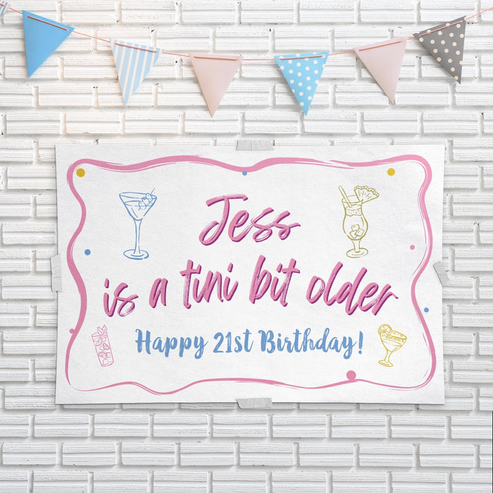 Birthday banner displayed on a white brick wall with decorative party bunting.