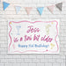 Birthday banner displayed on a white brick wall with decorative party bunting.