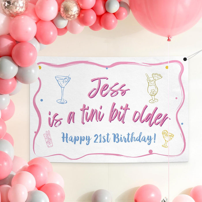 Birthday banner displayed as a party backdrop with pink balloon decorations featuring a custom name and age.