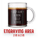 A glass mug with an engraved design on it. The mug is filled with tea, and there is text under the mug that reads "Engraving Area is 2 in x 2 in”