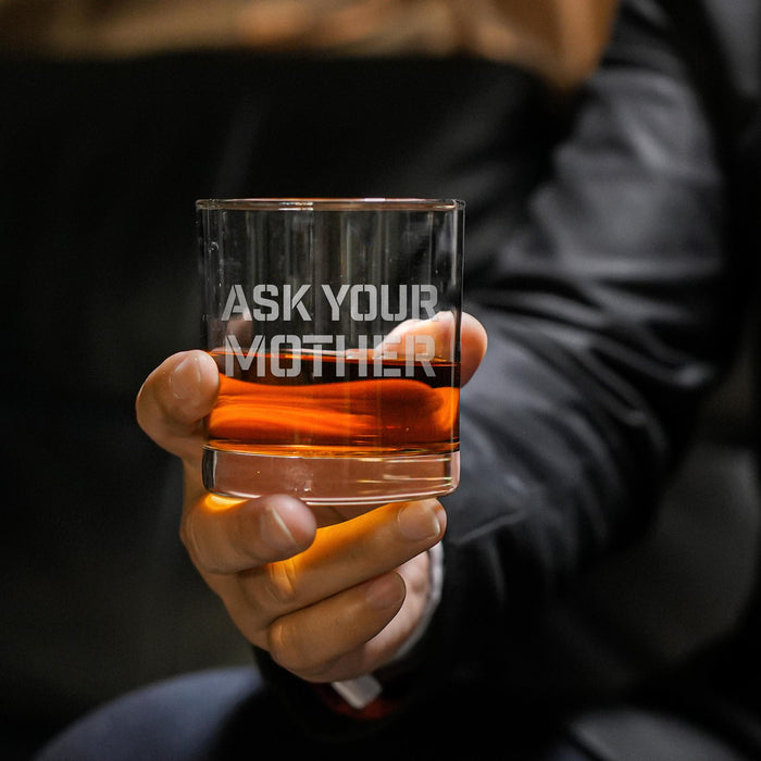Close-up lifestyle photo of a whiskey glass held in hand, featuring the “Ask Your Mother” engraving. The glass is filled with whiskey and ice, perfect for gifting.