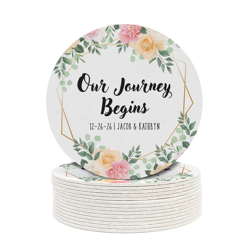 Personalized floral Save the Date coaster displayed beside a wine glass. Features a floral wedding design with custom details.