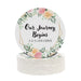 Personalized floral Save the Date coaster displayed beside a wine glass. Features a floral wedding design with custom details.
