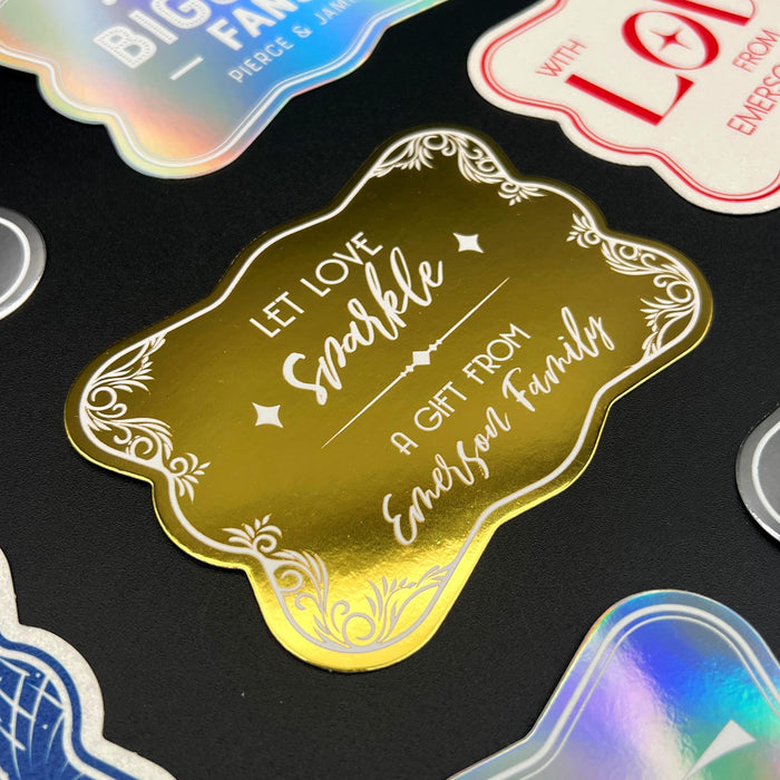 Close-up display of the personalized “Let Love Sparkle” wedding gift tag in gold foil with decorative flourishes and custom sender names. Styled as an elegant keepsake tag for weddings and bridal showers.