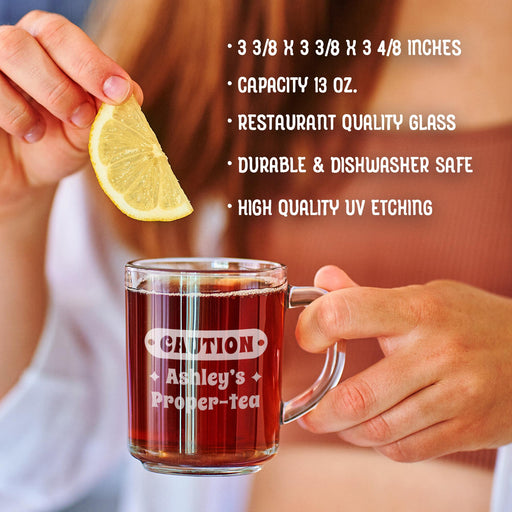 A person is holding a glass mug with a message engraved on it. The image is accompanied by a text overlay that reads • 3 3/8 x 3 3/8 x 3 4/8 inches • Capacity 13 oz. • restaurant quality glass • durable & dishwasher safe • high quality uv etching