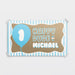 Personalized ONE Happy Dude first birthday banner printed on brown butcher paper with blue balloon graphic, striped border details, and custom name personalization.