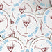 Several personalized martini coasters spread across a tabletop, each featuring the custom bar name, martini glass illustration, and established year.