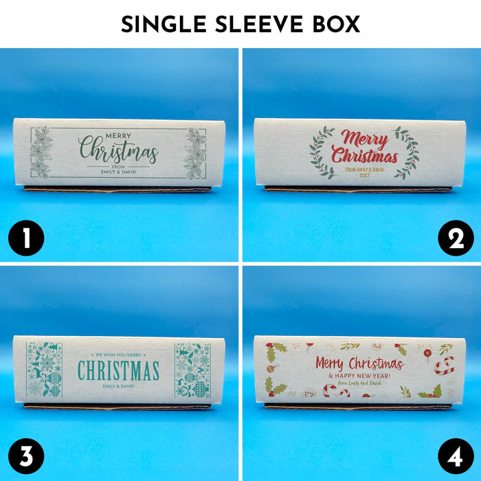 Single sleeve Christmas golf ball gift boxes shown in four printed designs, including botanical, wreath, blue sweater-style, and festive holiday illustration designs.