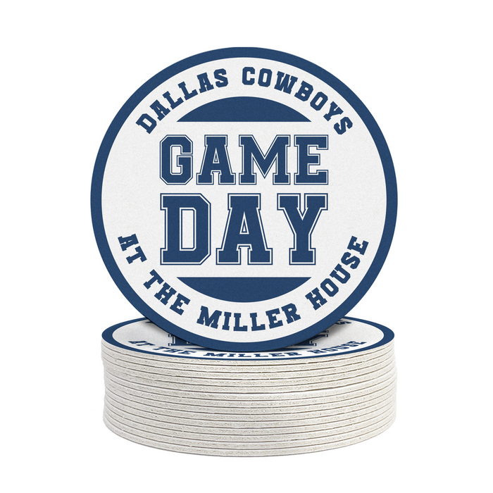 A stack of white coasters with the text "DALLAS COWBOYS GAME DAY AT THE MILLER HOUSE" printed on them.