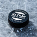 Personalized black hockey puck with a white UV printed birth announcement design featuring the baby’s name, birth date, weight, and length.