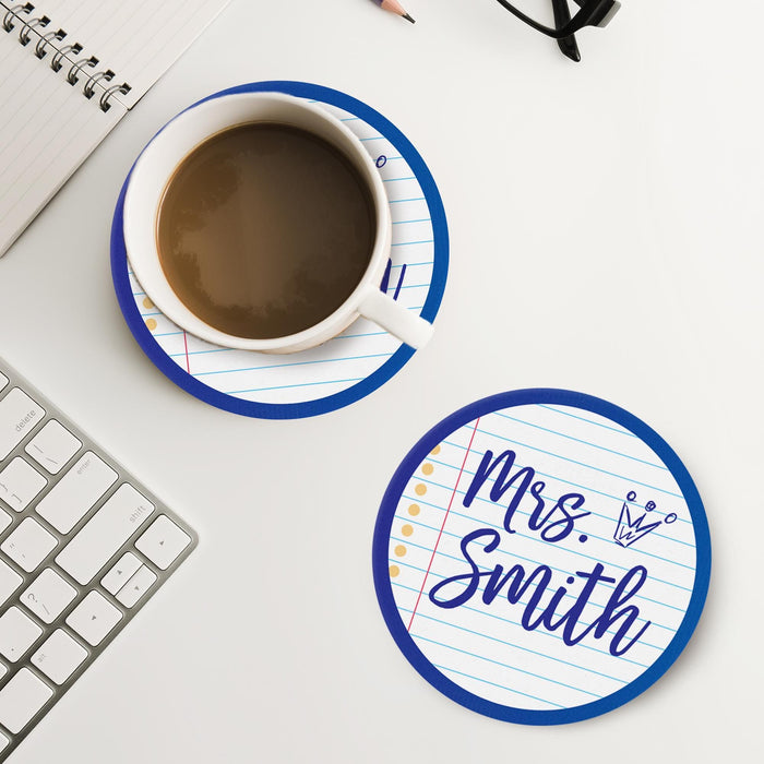 Notebook style coaster placed next to coffee and workspace items. Shows practical daily use.