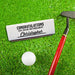 A white gift box for a single golf ball sleeve with a personalized printed message. This box is shown next to a golf club and a golf ball on a grassy surface.