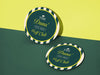 Custom round pulpboard coasters are shown sitting on a pink and green background. The custom coasters feature design printed with script and serif customizable text and striped background.