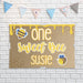 One Sweet Bee birthday backdrop displayed against a white brick wall showing the printed butcher paper material and playful bee theme design.