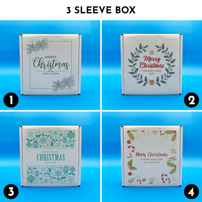 Three sleeve Christmas golf ball gift boxes shown in four printed designs, including botanical, wreath, blue sweater-style, and festive holiday illustration designs.