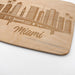 Close-up of the laser engraved Miami skyline with palm trees and Miami lettering on the maple cutting board.