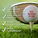a golf ball with a personalized message on it, placed on a tee on a grassy golf course.