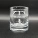 A clear glass with the name 'TURNER' engraved on it.