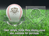 A personalized baseball with red stitching is placed on a clear acrylic stand, accompanied by a text overlay that reads Clear acrylic Home Plate display stand also available for purchase.