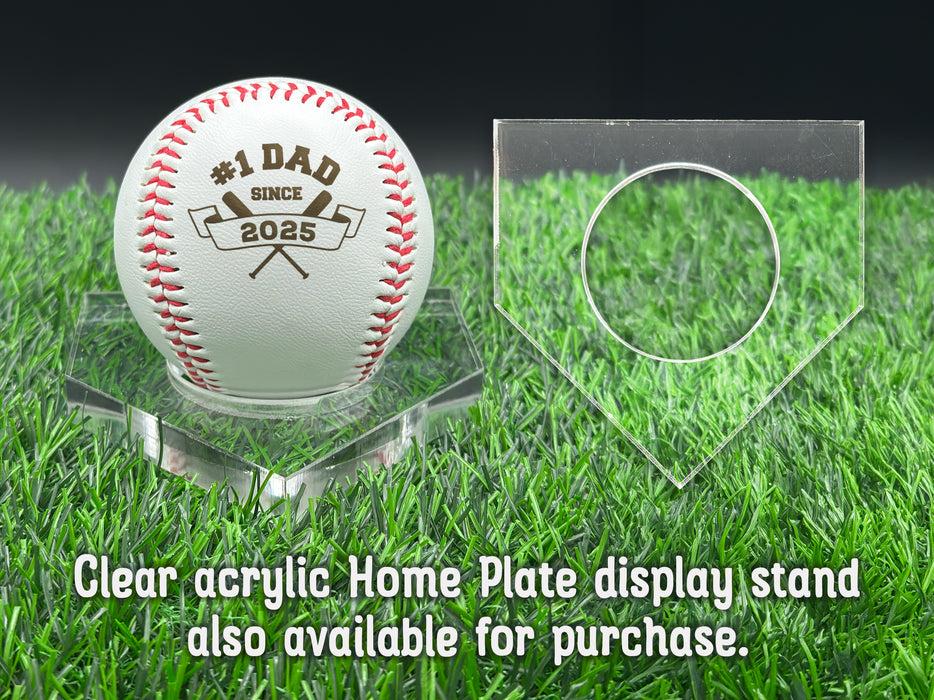 A personalized baseball with red stitching is placed on a clear acrylic stand, accompanied by a text overlay that reads Clear acrylic Home Plate display stand also available for purchase.