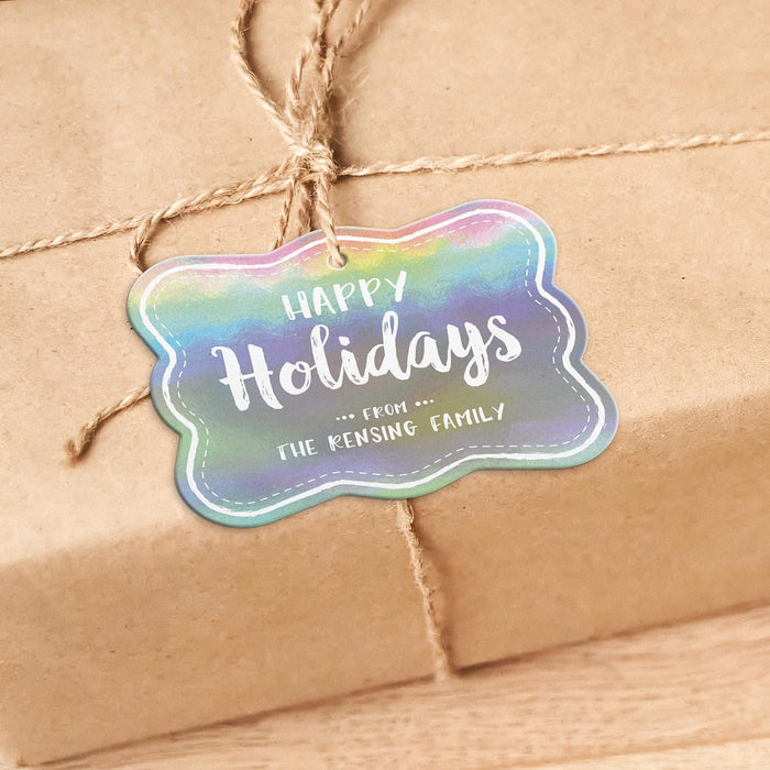 Personalized Happy Holidays rounded rectangle hang tag tied to a kraft paper wrapped gift with natural twine on a warm neutral background.