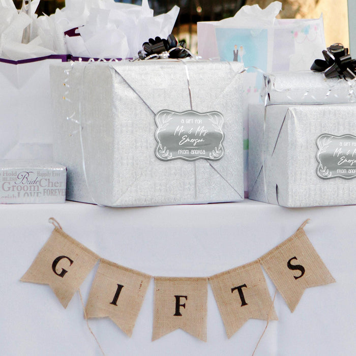 Silver wrapped gifts decorated with personalized “Mr. & Mrs.” foil wedding gift tags. Styled as elegant packaging ideas for weddings, bridal showers, and engagement celebrations.