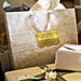 Wedding gift bags and favor boxes displayed with personalized “Let Your Adventure Begin” gold foil wedding gift tags. Styled for elegant weddings, bridal showers, and engagement celebrations.