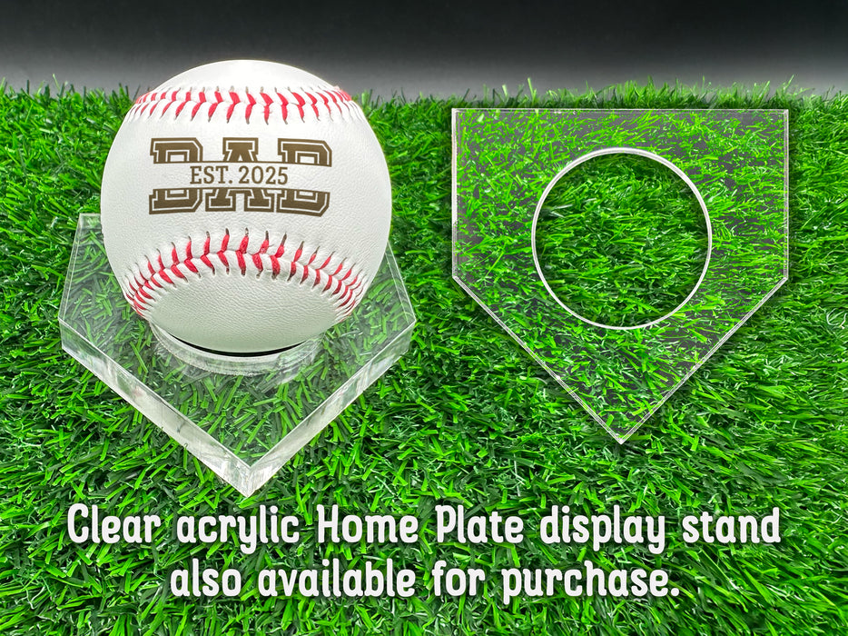 A personalized baseball with red stitching is placed on a clear acrylic stand, accompanied by a text overlay that reads Clear acrylic Home Plate display stand also available for purchase.