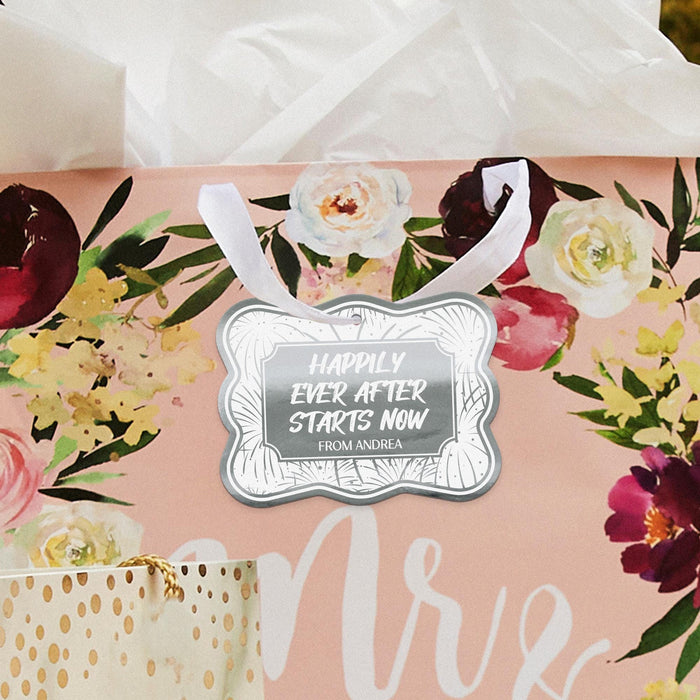 Pastel envelope with a rainbow foil “Happily Ever After Starts Now” wedding gift tag attached using ribbon. The personalized cardstock tag is styled for wedding stationery or bridal shower gifting.